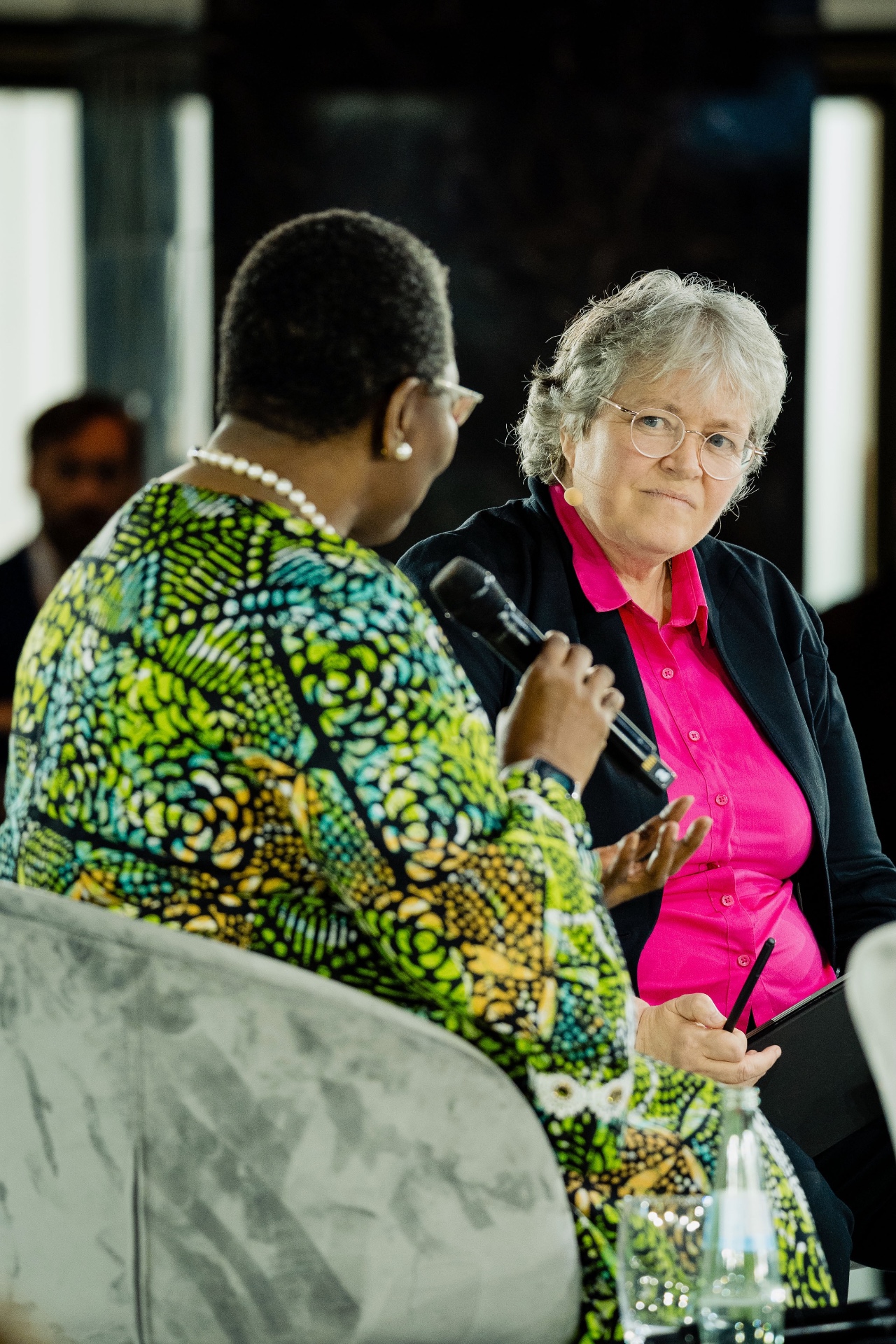 Susan Mackay listening attentively to a fellow panellist during a public discussion