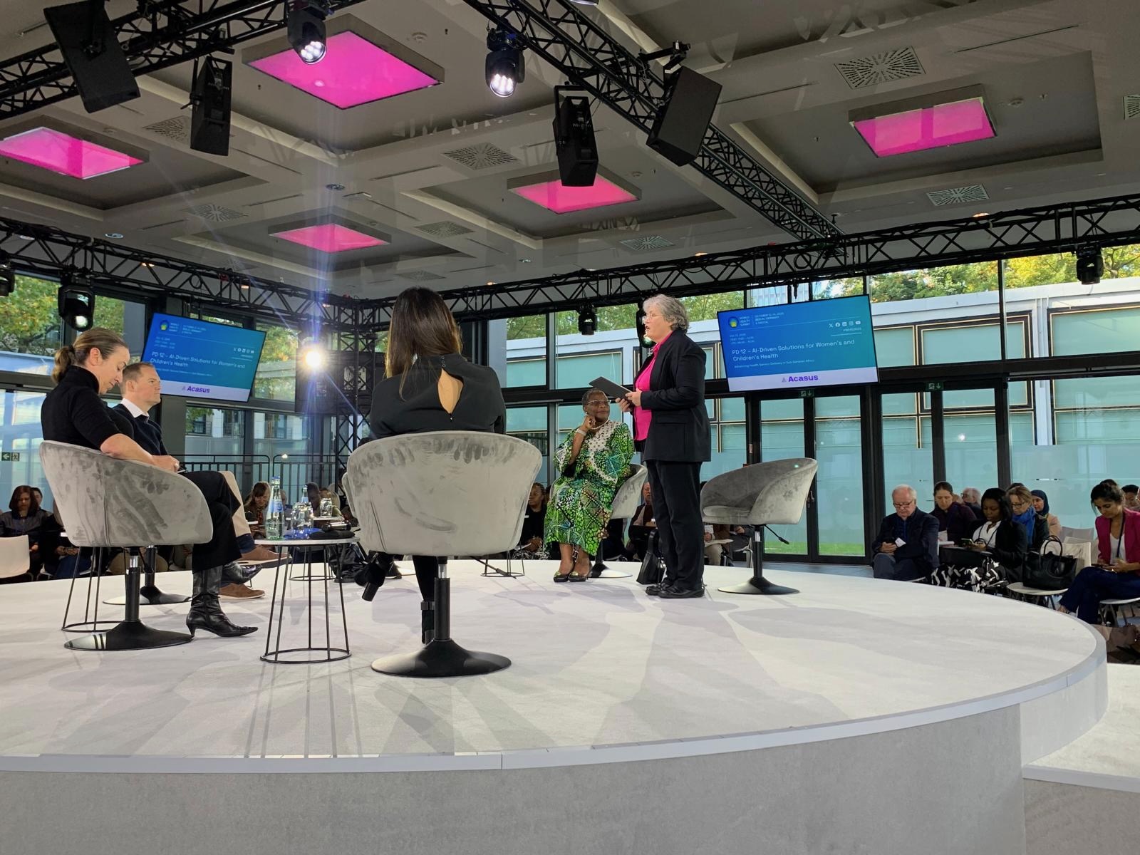 Susan Mackay speaking on a panel at an international conference.